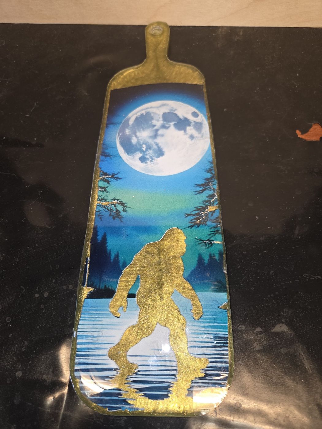 Small board with Bigfoot under a full moon