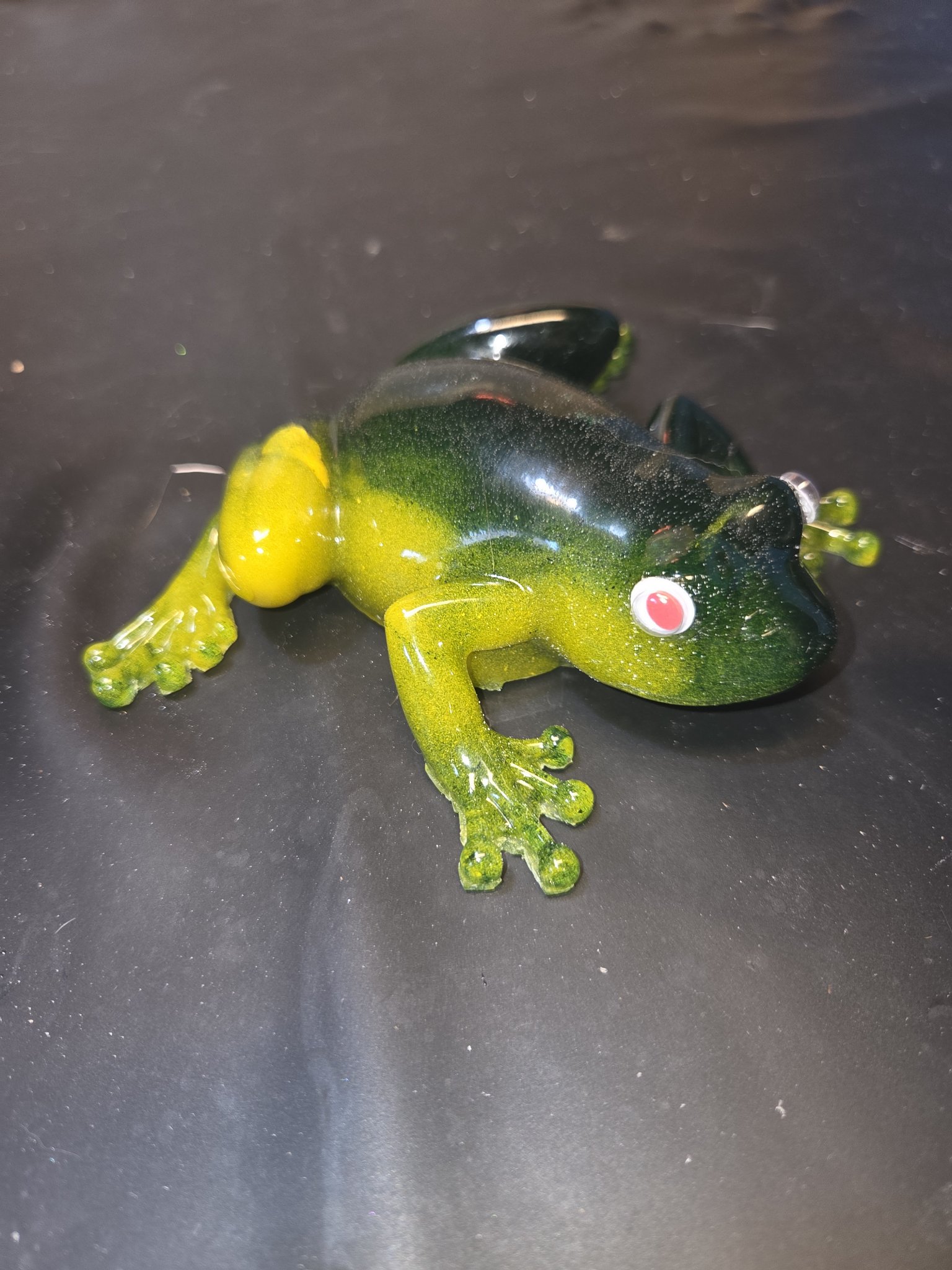 Green and yellow resin frog with googly eye